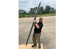 Pablo Zavattieri, the Jerry M. and Lynda T. Engelhardt Professor in Civil Engineering, lifts an aircraft runway mat made with new intelligent architected materials developed at Purdue University.