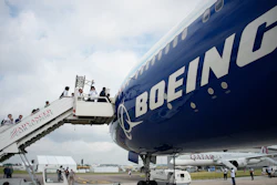 Visitors walk up the steps of the Boeing 777X airplane during the Paris Air Show in Le Bourget, north of Paris, France, Monday, June 19, 2023.