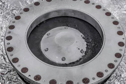 This photo provided by NASA on Wednesday, Oct. 11, 2023 shows the outside of the Osiris-Rex sample collector with material from asteroid Bennu at middle right. Scientists have found evidence of both carbon and water in initial analysis of this material. The bulk of the sample is lo(