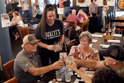 Macy Norman, center, serves a table of guests at Puckett's Grocery and Restaurant, Nashville, Sept. 10, 2021.