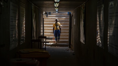 A miner walks at the entrance of a goldmine shaft in Springs, South Africa, Tuesday, Oct. 24, 2023.