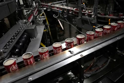 Coca-Cola cans move down a conveyer belt in the Swire Coca-Cola bottling plant Oct. 20, 2023, in Denver. Major corporations in water-guzzling industries such as apparel, food and beverage, and tech want to be better stewards of the freshwater resources they use. Coca-Cola said its water use in 2022 was about 10% more efficient compared to 2015.
