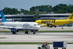 A JetBlue Airways Airbus A320, left, passes a Spirit Airlines Airbus A320 as it taxis on the runway, July 7, 2022, at the Fort Lauderdale-Hollywood International Airport in Fort Lauderdale, Fla.