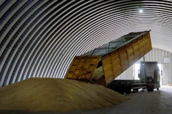 A dump track unloads grain in a granary in the village of Zghurivka, Ukraine, on Aug. 9, 2022. Ukraine, Poland and Lithuania have agreed on a plan they hope will help expedite Ukrainian grain exports, officials said Tuesday, Oct. 3, 2023, with needy countries beyond Europe potentially benefitting from speedier procedures.