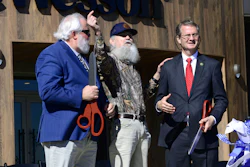 Blount County Mayor Ed Mitchell, from left, Si Robertson of 'Duck Dynasty' and U.S. Representative Tim Burchett, R-Tenn, hold their ceremonial scissors Saturday, Oct. 7, 2023, after helping cut the ribbon to officially open the new Smith & Wesson facility in Maryville, Tenn.