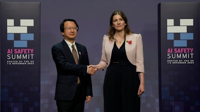 Britain's Michelle Donelan, Secretary of State for Science, Innovation and Technology, right, and Wu Zhaohui, Chinese Vice Minister of Science and Technology, shake hands prior to the AI Saftey Summit in Bletchley Park, Milton Keynes, England, Wednesday, Nov. 1, 2023.