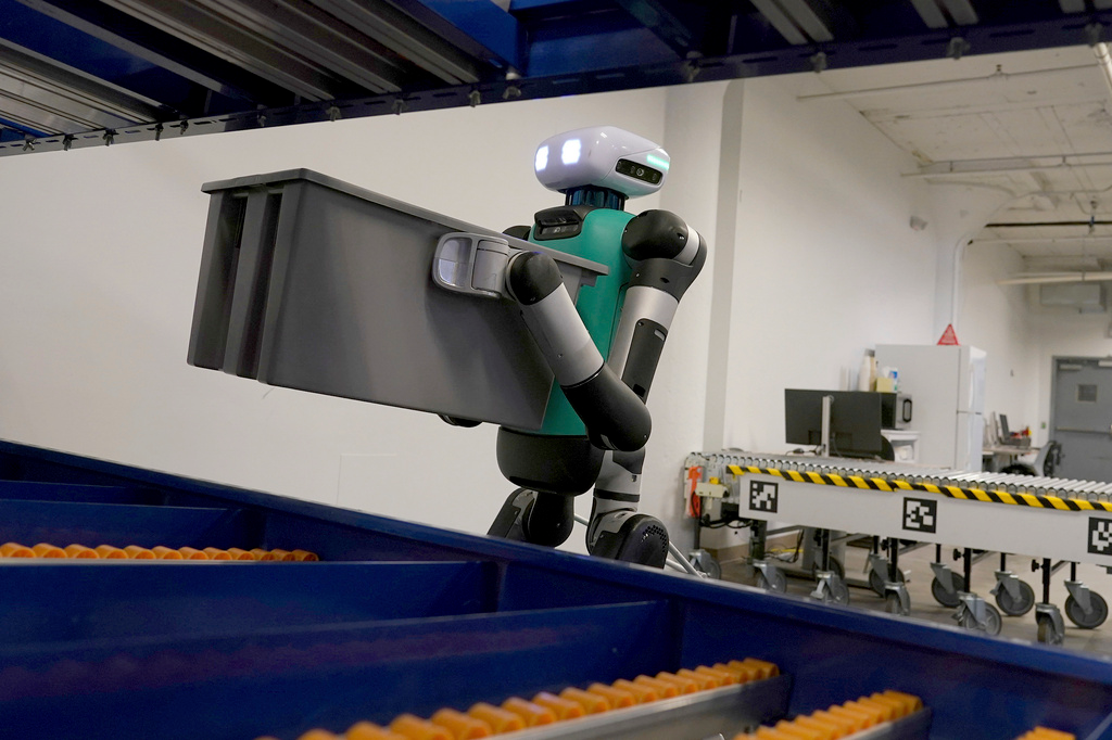 Agility Robotics' warehouse robot Digit performs maneuvers at the company's office in Pittsburgh, Wednesday, Aug. 16, 2023. Agility co-founder Jonathan Hurst makes a point of describing Digit as human-centric, not humanoid, a distinction meant to emphasize what it does over what it's trying to be.