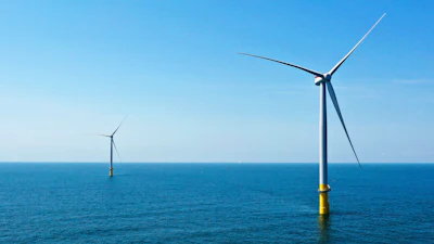 Two of the offshore wind turbines stand off the coast of Virginia Beach, Va., Monday, June 29, 2020.