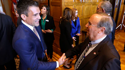 Patrick Howarth, left, global business manager, low carbon solutions for ExxonMobil, shakes hands with Sen. Mark Johnson, R-Little Rock, after an announcement of a new lithium extraction operations to start soon in south Arkansas, on Monday, Nov. 13, 2023, at the state Capitol in Little Rock, Ark.
