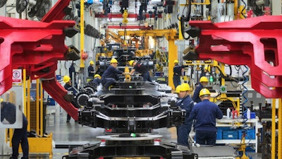 Workers assemble mini excavators in a factory of heavy machinery in Suzhou in eastern China's Jiangsu province on Oct. 23, 2023. An official survey of Chinese manufacturers showed that factory activity contracted for a second straight month in November, an indicator of weak demand even as policymakers have introduced stimulus measures to jumpstart the economy.