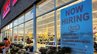 A hiring sign is displayed at a grocery store in Deerfield, Ill., Thursday, Oct. 5, 2023.
