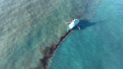 In this photo provided by the U.S. Coast Guard, a Clean Gulf Associates 95-foot response vessel skims crude oil approximately 4 miles southeast off South Pass Louisiana, Friday, Nov. 17, 2023.