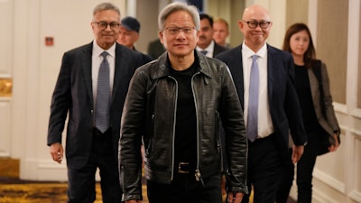 Nvidia CEO and co-founder Jensen Huang, center, arrives for a media round table event at a hotel in Kuala Lumpur, Malaysia Friday, Dec. 8, 2023.