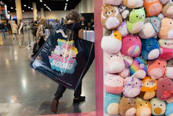 A shareholder leaves the Squishmallows booth with a large bag of purchases in the exhibition hall of the Berkshire Hathaway annual meeting on Saturday, May 6, 2023, in Omaha, Neb.