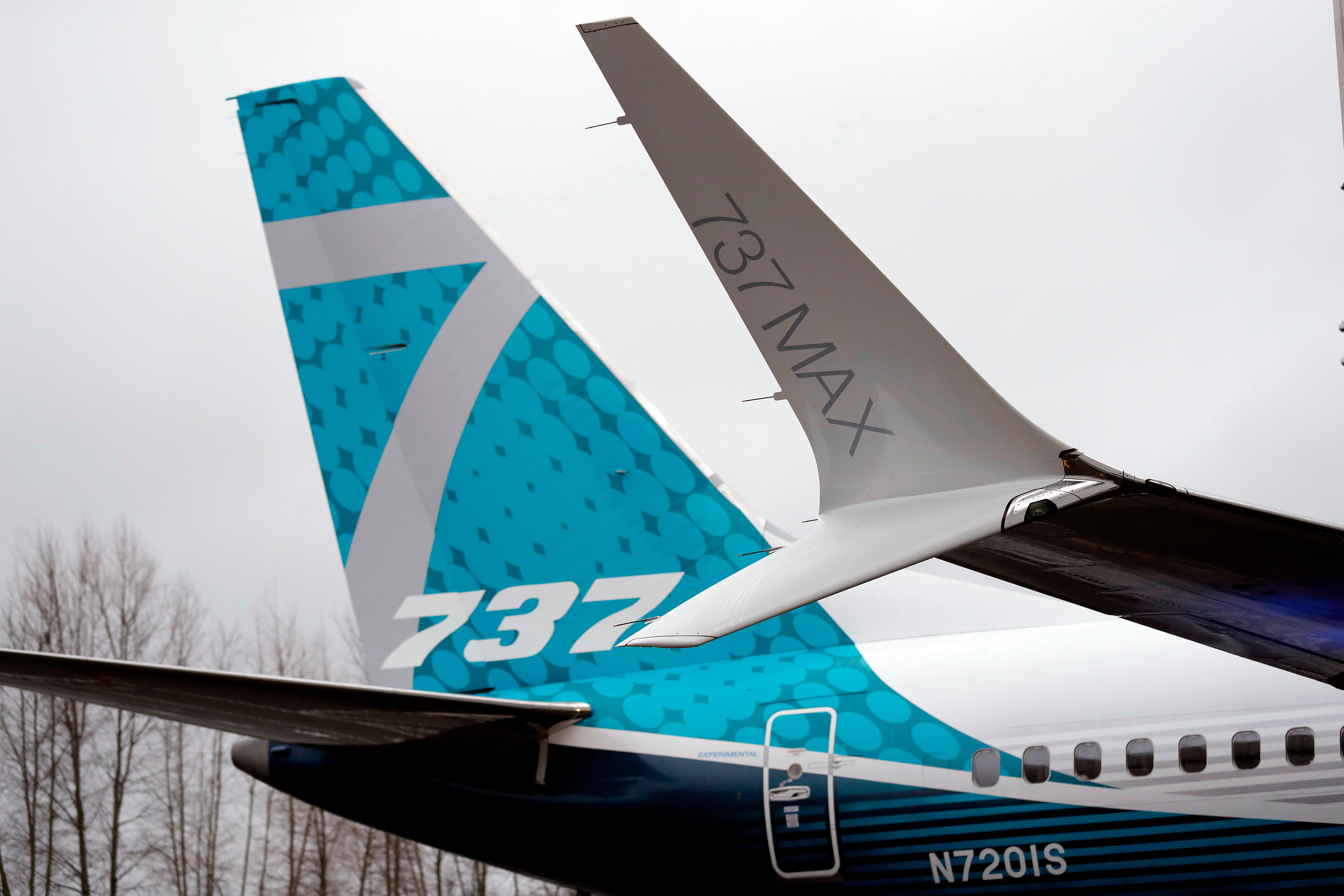 In this Feb. 5, 2018, file photo, a dual-tipped wing tip, known as a 'winglet,' stands in view of the tail of a Boeing 737 MAX 7, the newest version of Boeing's fastest-selling airplane, while displayed during a debut for employees and media of the new jet in Renton, Wash.