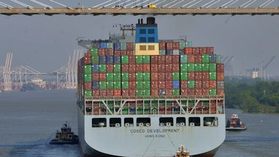 The container ship COSCO Development is guided under the Talmadge Bridge in Savannah, Ga., May 11, 2017.