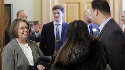 Kansas Supreme Court Chief Justice Marla Luckert, left, chats with spectators who have gathered for a joint meeting of the Kansas House and Senate Judiciary committees.