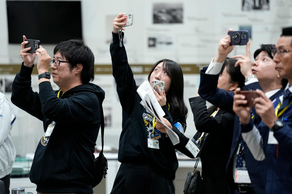Staff of Japan Aerospace Exploration Agency (JAXA) watch a live streaming of the pinpoint moon landing operation by the Smart Lander for Investigating Moon (SLIM) spacecraft observe a live streaming at JAXA's Sagamihara Campus Saturday, Jan. 20, 2024, in Sagamihara near Tokyo.