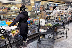 Customers wait for orders at a grocery store in Wheeling, Ill., Jan. 19, 2024.