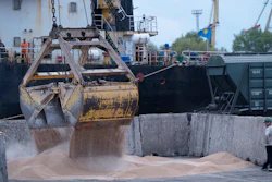 Workers load grain at a port in Izmail, Ukraine, April 26, 2023.