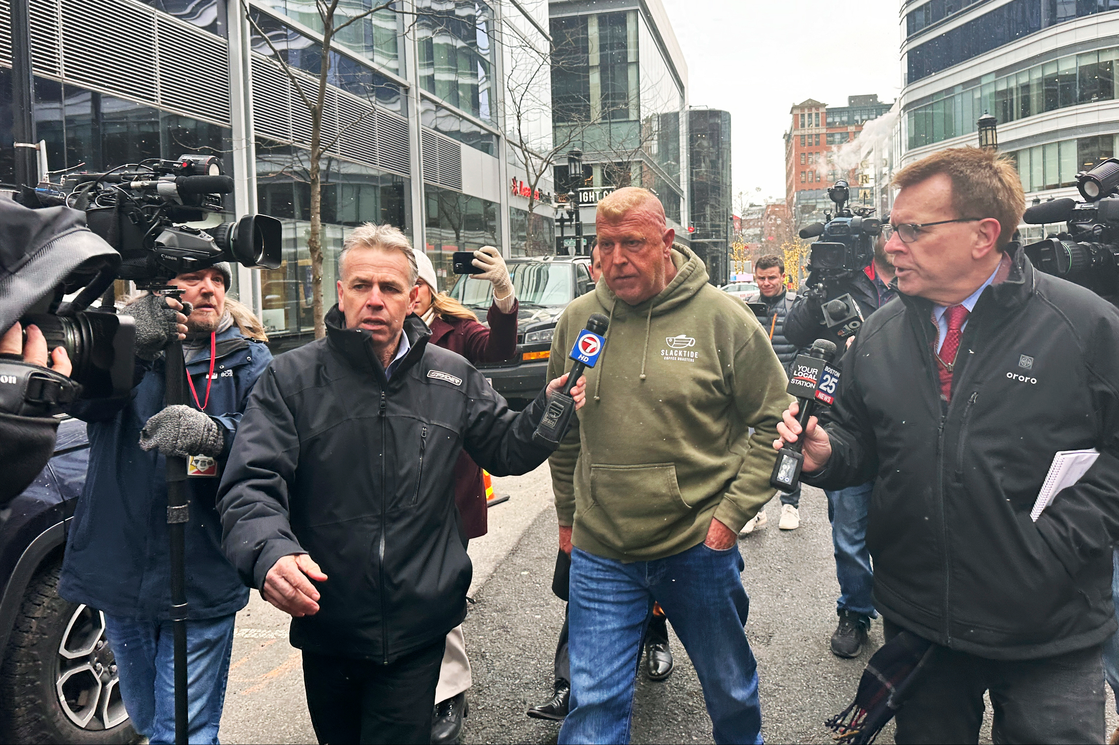 Massachusetts State Police Sgt. Gary Cederquist, center, leaves federal court in Boston, Jan 30, 2024.