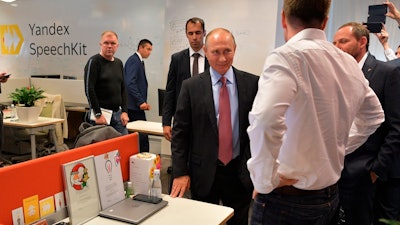 Russian President Vladimir Putin, center, visits Russia's largest internet search engine Yandex headquarters in Moscow, Russia, on Sept. 21, 2017.