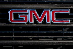 A GMC company logo is displayed at a GMC Truck dealership Sunday, Feb. 7, 2021, in Castle Rock, Colo.