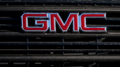 A GMC company logo is displayed at a GMC Truck dealership Sunday, Feb. 7, 2021, in Castle Rock, Colo.