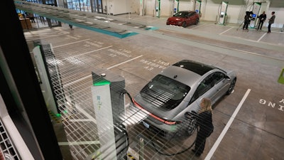 A car gets charged at the new Electrify America indoor electric vehicle charging station during a preview in San Francisco, Wednesday, Feb. 7, 2024.