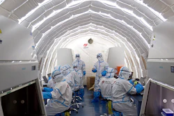 In this file photo released by China's Xinhua News Agency, staff members work in an inflatable COVID-19 testing lab provided by Chinese biotech company BGI Genomics, a subsidiary of BGI Group, in Beijing, June 23, 2020. Members of Congress are raising alarms about what they see as America's failure to compete with China in biotechnology, with risks to U.S. national security and commercial interests.