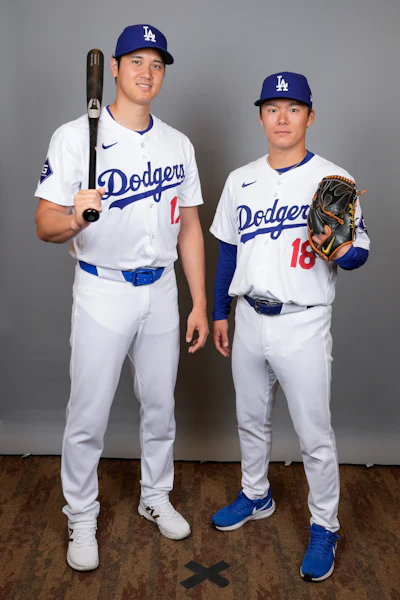 Los Angeles Dodgers designated hitter Shohei Ohtani, left, and starting pitcher Yoshinobu Yamamoto pose for a photo during a spring training baseball photo day on Wednesday, Feb. 21, 2024, in Phoenix.