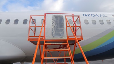 This photo released by the National Transportation Safety Board shows a gaping hole where the paneled-over door had been at the fuselage plug area of Alaska Airlines Flight 1282, Jan. 7, 2024, in Portland, Ore.