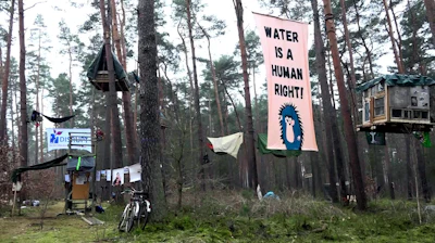 Activists occupy an area in the forest in Groenheide, Germany, Friday March 1, 2024.