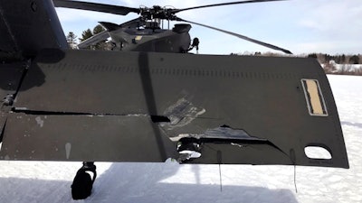In this U.S. Army photograph by attorney Douglas Desjardins, a damaged Black Hawk helicopter rests on the snow, March 13, 2019, in Worthington, Mass.