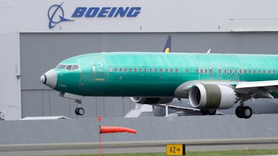 In this April 10, 2019, file photo, a Boeing 737 Max 8 airplane lands following a test flight at Boeing Field in Seattle.