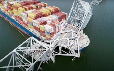 In this image taken from video released by the National Transportation and Safety Board, the cargo ship Dali is stuck under part of the structure of the Francis Scott Key Bridge after the ship hit the bridge, Tuesday, March 26, 2024, in Baltimore.