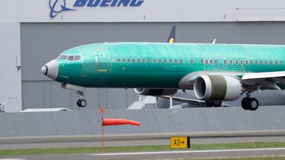 In this April 10, 2019, file photo, a Boeing 737 Max 8 airplane lands following a test flight at Boeing Field in Seattle.