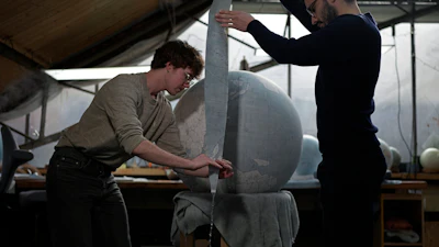 Artists make a globe at a studio in London, Tuesday, Feb. 27, 2024. Globes in the age of Google Earth capture the imagination and serve as snapshots of how the owners see the world and their place in it.