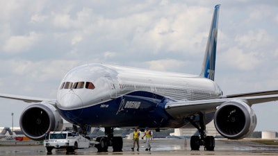 Boeing employees walk the new Boeing 787-10 Dreamliner down towards the delivery ramp area at the company's facility after conducting its first test flight at Charleston International Airport, Friday, March 31, 2017, in North Charleston, S.C.