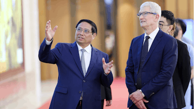 Vietnamese Prime Minister Pham Minh Chinh, left, speaks to Apple CEO Tim Cook, right, before their meeting in Hanoi, Vietnam on Tuesday, April 16, 2024.