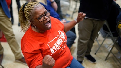 Volkswagen automobile plant employee Vicky Holloway celebrates as she watches the results of a UAW union vote, late Friday, April 19, 2024, in Chattanooga, Tenn.