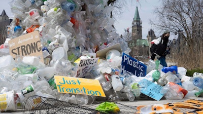 A person walks past an art installation outside a United Nations conference on plastics on April 23, 2024, in Ottawa, Ontario.