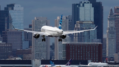 A plane lands at Logan International Airport, Thursday, Jan. 26, 2023, in Boston.