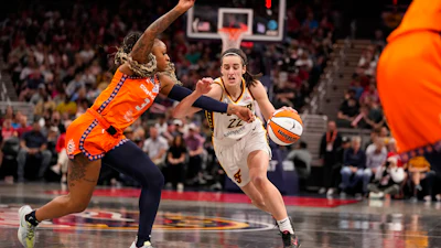Indiana Fever guard Caitlin Clark (22) drives on Connecticut Sun guard Tiffany Mitchell (3) in the second half of a WNBA basketball game in Indianapolis, Monday, May 20, 2024.