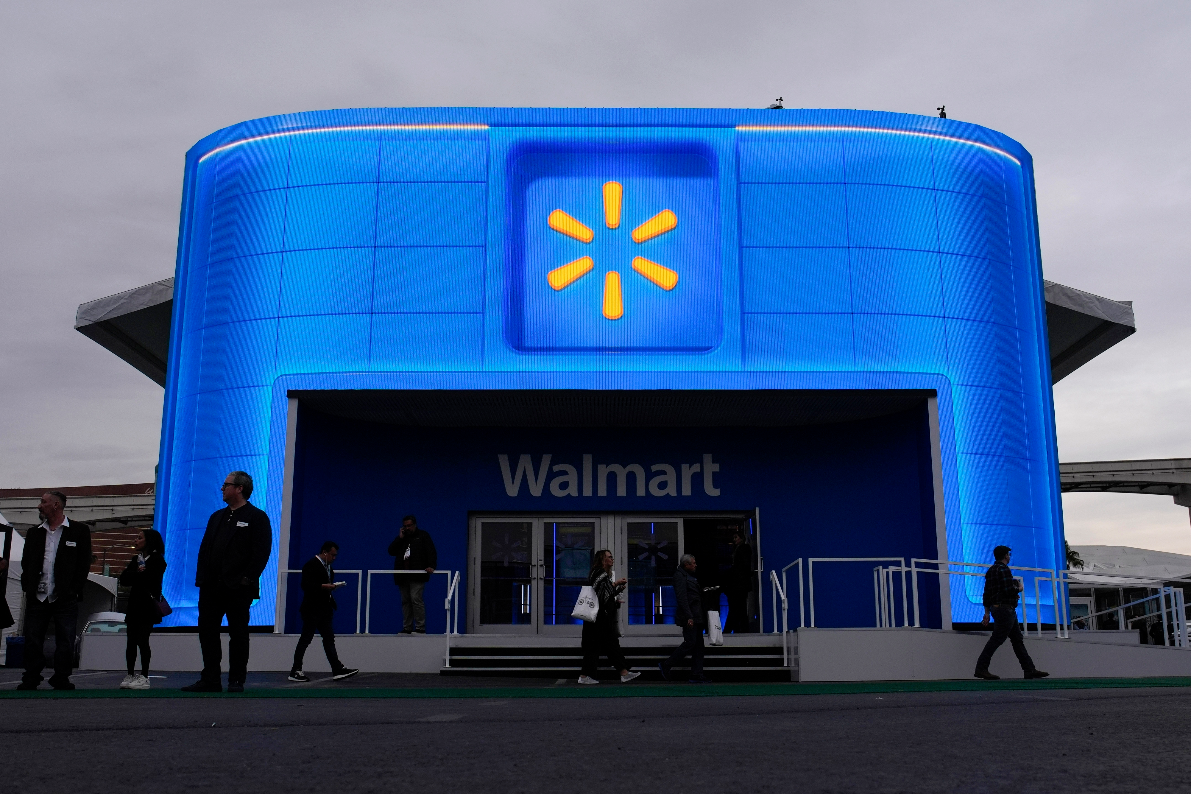 People walk by the Walmart booth during the CES tech show Tuesday, Jan. 9, 2024, in Las Vegas.