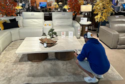 A shopper pauses at a display in a furniture store in Englewood, Colo., June 2, 2024.