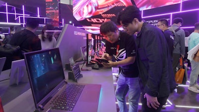 Visitors review new computer products during the Computex Taipei exhibition.