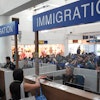 Officers check the passports of passengers leaving for Singapore at the immigration checkpoint of the Bandar Bentan Telani ferry terminal on Bintan Island, Indonesia.