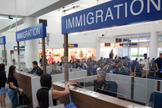 Officers check the passports of passengers leaving for Singapore at the immigration checkpoint of the Bandar Bentan Telani ferry terminal on Bintan Island, Indonesia.