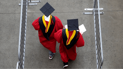 In this May 13, 2018, file photo, new graduates walk into the High Point Solutions Stadium before the start of the Rutgers University graduation ceremony in Piscataway Township, N.J.